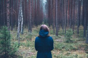 Woman trying to find her way through woods