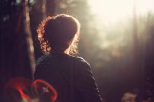 Thoughtful woman looking toward a bright path