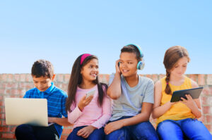 Children with computers, tablets, cell phones and head phones